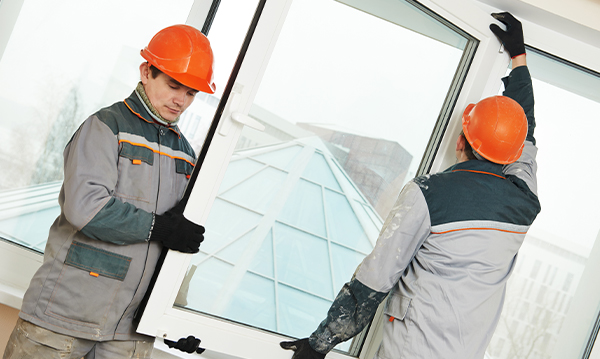 two window installers setting a new window