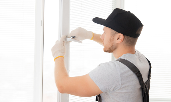 man installing a window handle