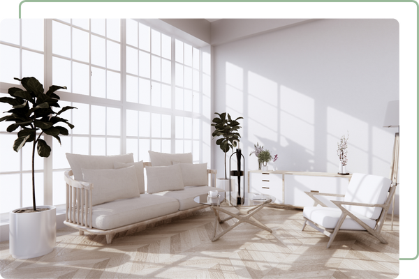 White living room with full height bay windows streaming light in from behind the furniture.