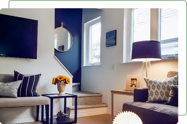 living room windows, facing stairs with blue finishes on walls and furniture.