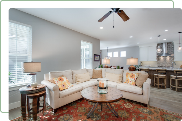 living room with a corner couch in front of a wall of windows