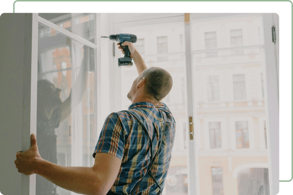 man installing new swinging window