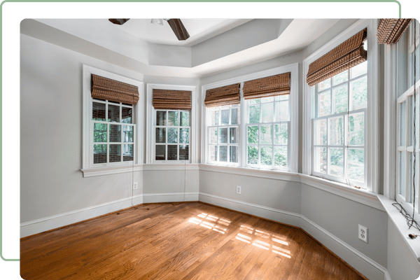 empty office with wood floors and a curved wall with windows in each section