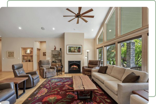 living room with high ceilings and a window wall on the right